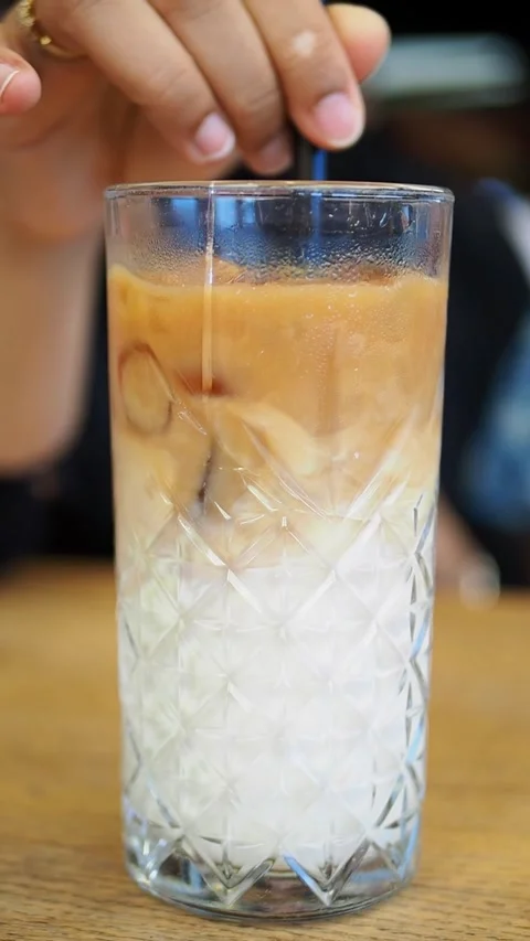 Bartender stirs an orange drink with ice at a cafe counter Stock Footage 347997341