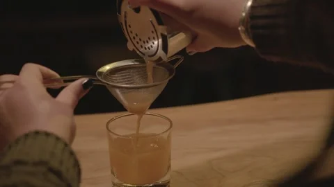 Bartender Straining Cocktail Into Glass at Bar Counter in Beijing, China Stock Footage 345747934