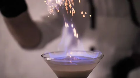 Bartender Strew Cinnamon Powder to Flame of Cocktail, Flaming Cocktail Alcohol Stock Footage 133215783
