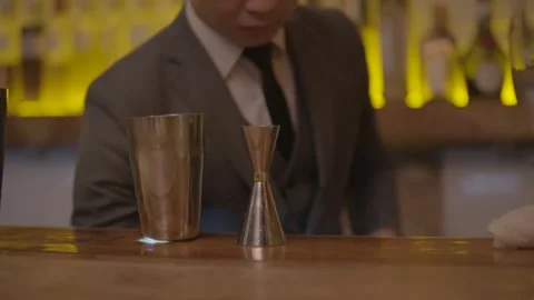 Bartender in Suit Prepares Drinks with Jigger and Shaker at Bar in Beijing Stock Footage 345753163