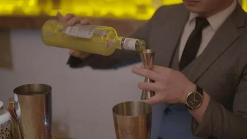 Bartender in Suit Preparing and Pouring Drink at Bar Counter in Beijing, China Stock Footage 345753105