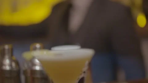 Bartender in Suit Serving Yellow Cocktail at Bar Counter in Beijing, China Stock Footage 345752627