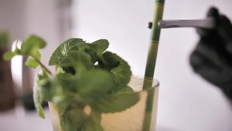 Bartender Takes a Cocktail Paper Straw and Inserts it Into a Cocktail Glass Stock Footage 134129209