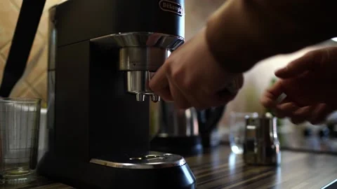 Bartender takes the cone out of the coffee machine by pressing the button Stock Footage 270349439