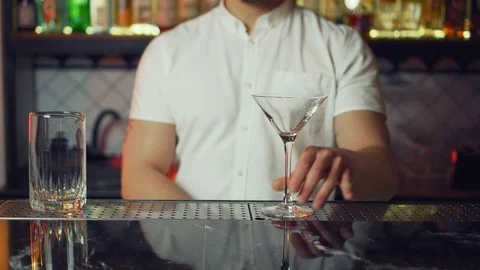Bartender takes a scoop, grabs some ice from a bucket and pours ice cubes Stock Footage 126299259