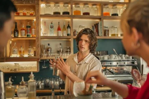 Bartender taking drink orders from customers in a trendy bar Stock Photos