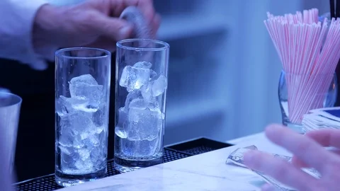 Bartender taking glass with ice away 스톡 동영상 107950435