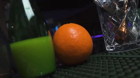 Bartender taking orange and peeling it in drink Stock Footage 90123029