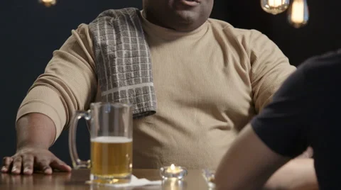 Bartender talking with a guy at the bar Stock Footage 62932858