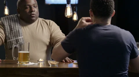 Bartender talking with his customer at the bar Video stock 62934342