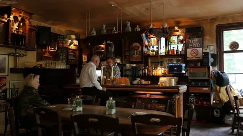 Bartender tapping beer and serving twoo beers in typical old Utrecht café 動画素材 76697093