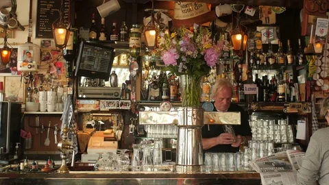 Bartender tapping beer in typical old Amsterdam café 動画素材 76697156