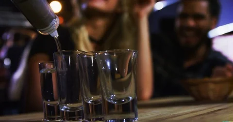 Bartender tequila in shot glasses in bar Stock Footage 80010802