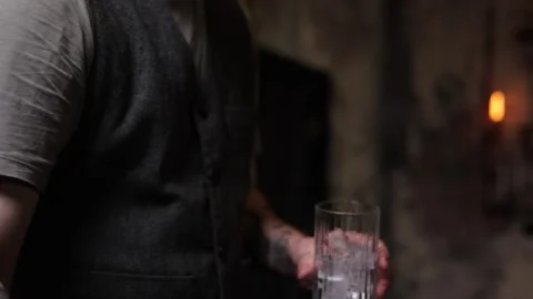 The bartender throws ice into the glass slow motion bar Stock Footage 168294877