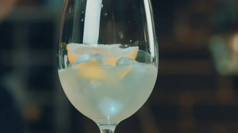 The bartender throws a lemon in a glass with ice Stock Footage 52194514