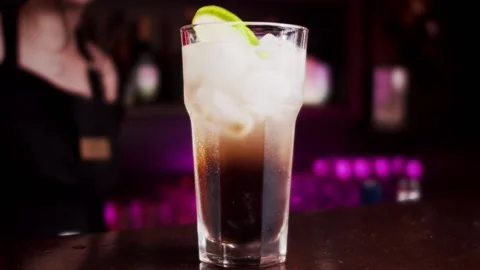 Bartender throws lime into a cocktail with Coca-Cola and ice Vídeo Stock 159139988