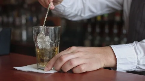Bartender turns the ice with spoon Stock Footage 74217094