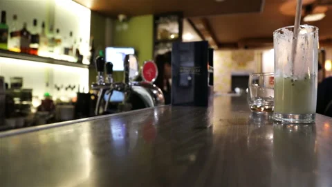 The bartender in the uniform is serving clients Stock Footage 106098033