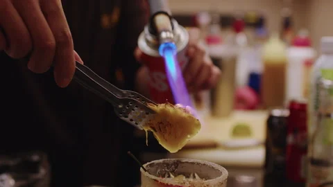 Bartender Uses Torch to Caramelize Pineapple Garnish for Cocktail at Bar 스톡 동영상 342286449