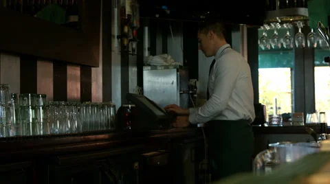 Bartender using cash register and tidying up the counter 库存影片 56876195