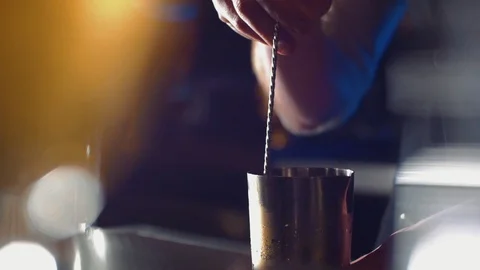 Bartender using long metal spoon to mix ice in shaker. Stock Footage 114243437