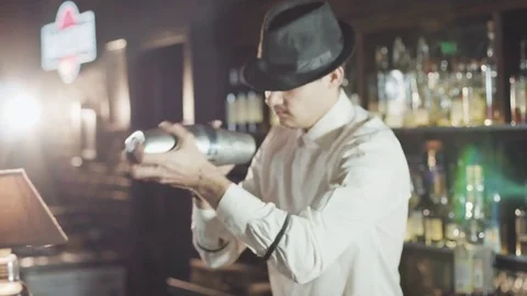 Bartender using shaker while preparing cocktail in night bar Stock Footage 75232140