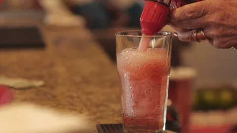 A bartender using a soda gun to make a drink Stock-Footage 116704225