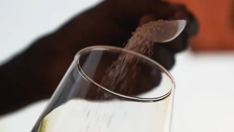 Bartender using a spoon to add brown sugar into glass Stock Footage 230080389