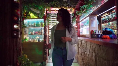 Bartender walking through jungle themed bar Stock Footage 309570288