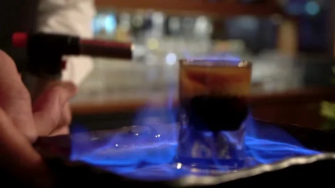 A bartender who sets fire to her cocktail. Stock Footage 244940880