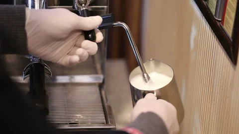 Bartender at work preparing hot milk foam, making espresso and steam milk 스톡 동영상 96444273