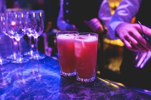 Bartender working, beautiful row line of different coloured liquor alcohol .. Stock Photos