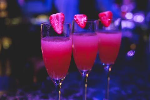 Bartender working, beautiful row line of different coloured liquor alcohol .. Stock Photos