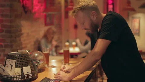 Bartender Writing Notes At Bar Counter With Beer Glasses Stock Footage 344667536