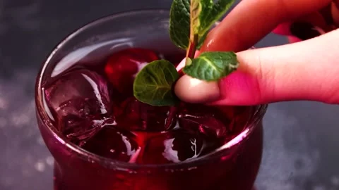The bartender's hand added mint to the drink Stock Footage 176389896