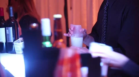 Bartenders preparing drinks for people at night time event close up Stock Footage 46037833