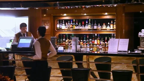 Bartenders work at bar with bottles on background of cruise ship in Genoa, Italy Stock Footage 71815041