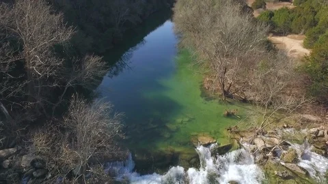 Barton Creek Austin Texas streaming waterfall tilting up drone 4k Stock Footage 101305540