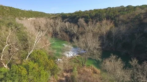 Barton Creek Austin Texas streaming waterfall tilting down drone 4k Stock Footage 101309102