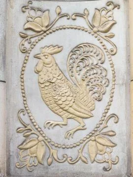 Bas-relief with a cock Stock Photos