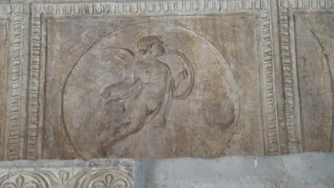 Bas-relief of a cupid on a wall of a building at pompeii Stock Footage 130644830