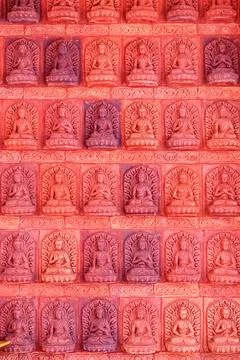 A bas-relief with multiple Buddha figures in Nanshan Park, Sanya, Hainan. Stock Photos