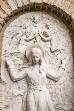 Bas relief representing the Virgin Mary surrounded by angels. Stock Photos