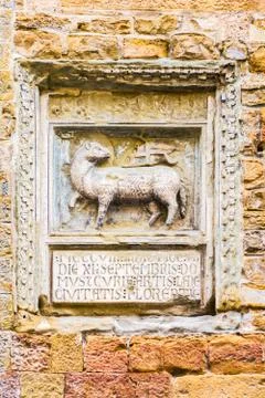 Bas-relief of a sheep with a flag on the wall of an old building in florence Stock Photos