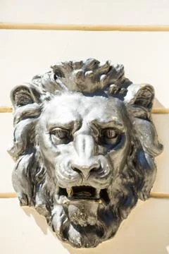 Bas-relief on the wall of light concrete with a lion's head Stock Photos