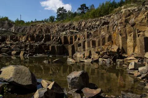 Basalt for building. Basalt career. Basalt pillars. Stone excavation. Heavy Stock Photos