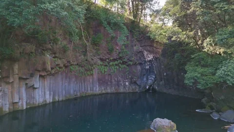 Basalt Cliff and Emerald Water Lagoon Aerial Shot Stock Footage 341123451