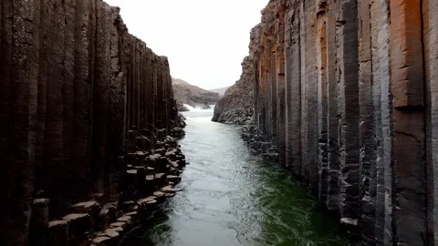 Basalt Columns of Studlagil Canyon with River in Iceland Stock Footage 296556346
