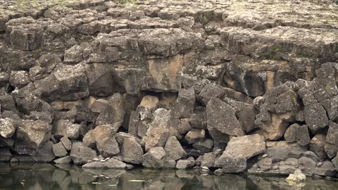 Basalt lava plain with lake water and dark volcanic - Shoreline and Rocky Shore Stock Footage 339405855