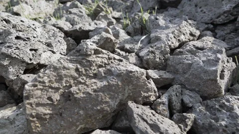 Basalt lava plain with porous volcanic rocks - Basalt Texture and Volcanic Soil Stock Footage 339403117